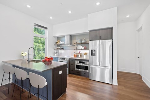 a kitchen with a large island and a stainless steel refrigerator at Four23/Hoge, Ohio